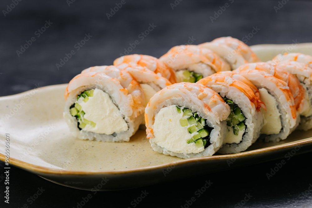 Shrimp sushi rolls Philadelphia with creamy filling and cucumber, Japanese cuisine themes Shrimp sushi rolls Philadelphia with creamy filling and cucumber, Japanese cuisine themes
