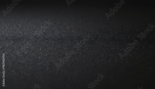 Dark textured surface with a subtle gradient from black to dark grey.