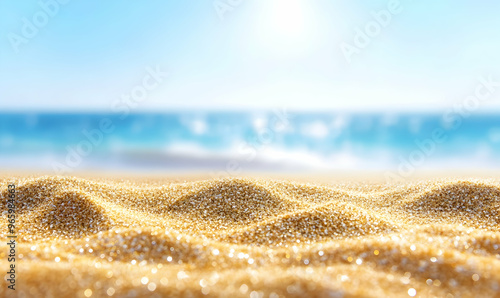 Closeup of golden sand with blurred ocean and sky in the background.