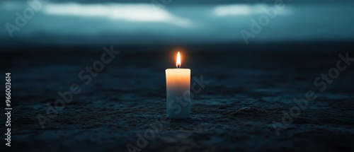 A serene image of a lit candle in a dark setting, symbolizing hope and peace amidst uncertainty and shadows.