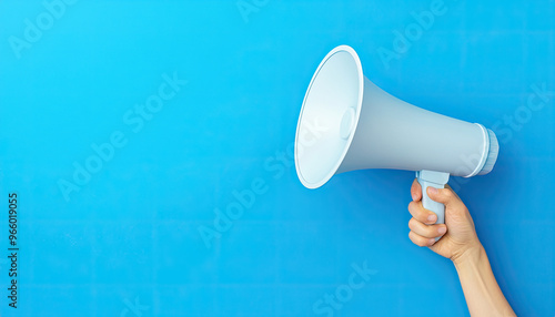 A hand holding a megaphone against a blue background, symbolizing communication and broadcasting messages effectively.