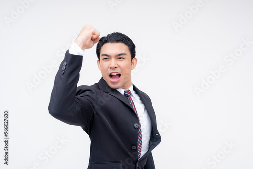 A confident and overzealous young asian business executive looking pumped up and yelling. Ready for any challenge. Isolated on a white background. photo