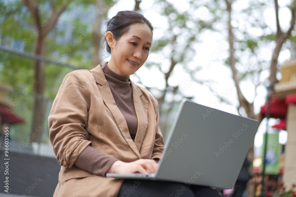 Professional Woman Working on Laptop in Outdoor Setting Professional Woman Working on Laptop in Outdoor Setting