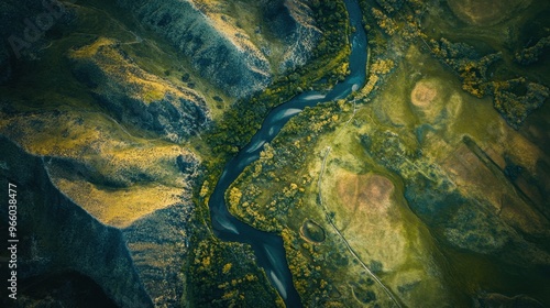 A river is shown in a green field with trees and hills in the background