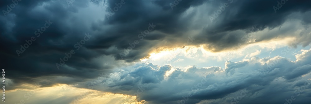 Obraz premium Dramatic Sunset with Storm Clouds and Bright Sun Rays Breaking Through