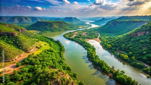 An Aerial View Of The Meandering Narmada River In India, With Lush Green Vegetation And Surrounding Hills