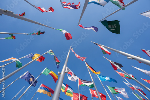 Various flags of the world against the blue sky.
