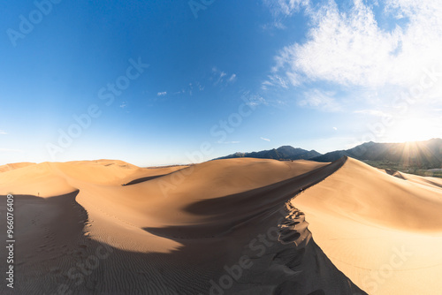 Panoramic view of Great Sand Dunes National Park with mountains in the background