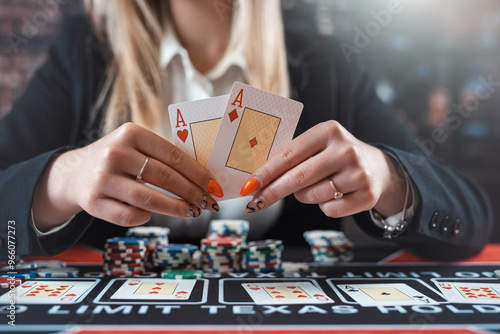 Obraz na plátně female player showing two aces and gambling chips in poker game at casino table