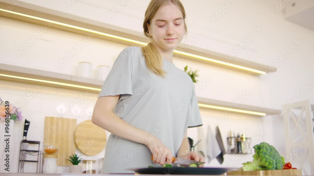In a bright and modern kitchen, a young woman enthusiastically prepares delicious dishes and dances happily, demonstrating her incredible culinary skills and creativity. In a bright and modern kitchen, a young woman enthusiastically prepares delicious dishes and dances happily, demonstrating her incredible culinary skills and creativity.
