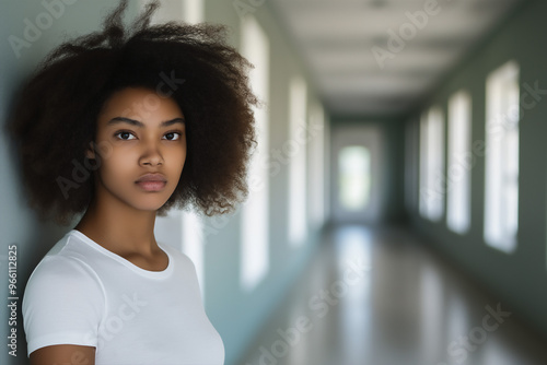 Free Download Young Gen Z African-American woman with sad expression standing in school hallway, mental health awareness, copy space - GFXLoad
