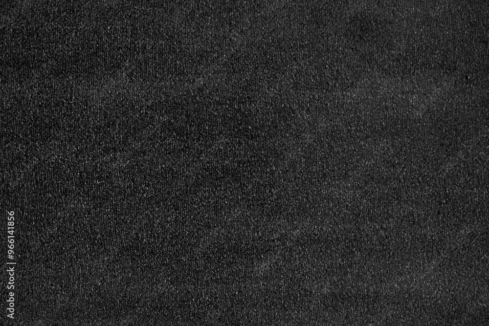 Textured black cotton canvas surface, featuring a subtle sheen and fine grain. The surface appears smooth yet has a slight depth, creating an elegant and modern aesthetic.