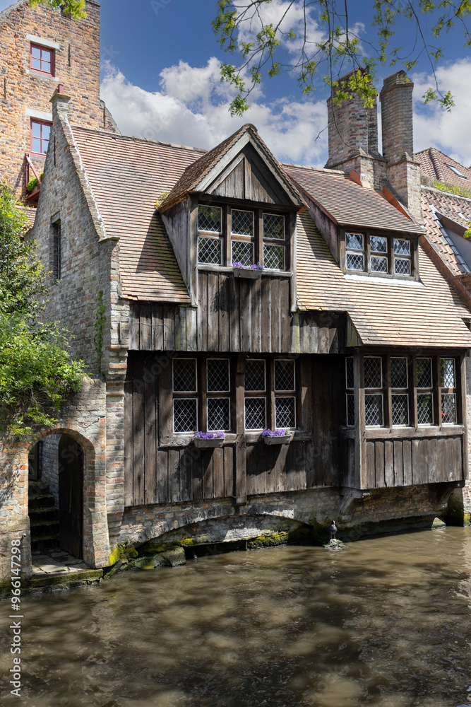 Picturesque view of water channels of the city near Beguinage Houses (Begijnhof), Bruges, Belgium