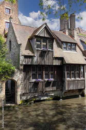 Obraz na płótnie Picturesque view of water channels of the city near Beguinage Houses (Begijnhof), Bruges, Belgium w salonie