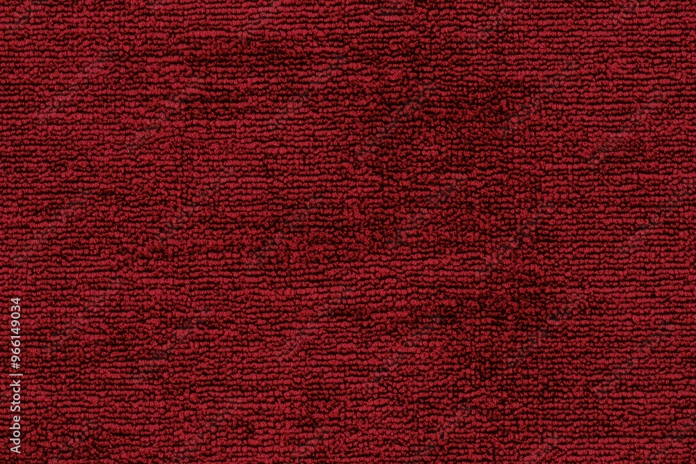 Fototapeta premium Textured red cotton chenille carpet, showcasing its rich color and soft fibers. The surface appears plush and inviting, perfect for interior decor.