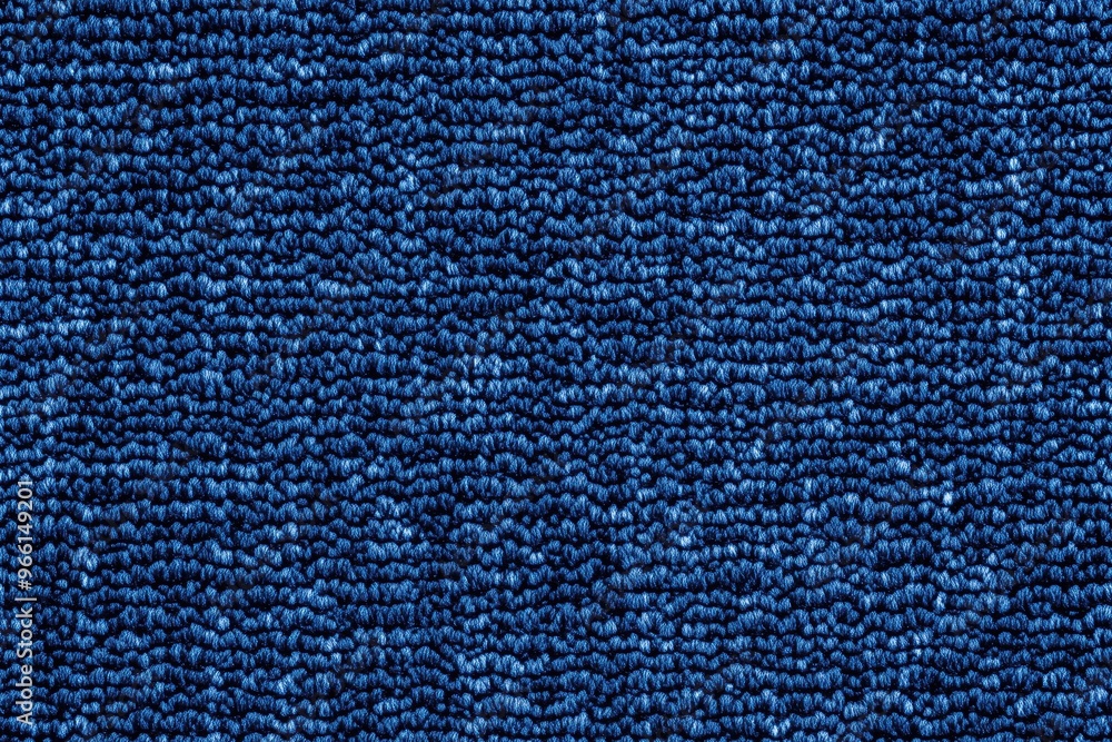 Textured blue cotton chenille fabric with a woven pattern, showcasing a rich, deep blue color. Textured blue cotton chenille fabric with a woven pattern, showcasing a rich, deep blue color.