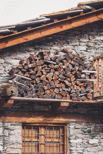 Pontechianle, Italy. Wooden logs stacked on the wall of a mountain house. Mountain Wood photo