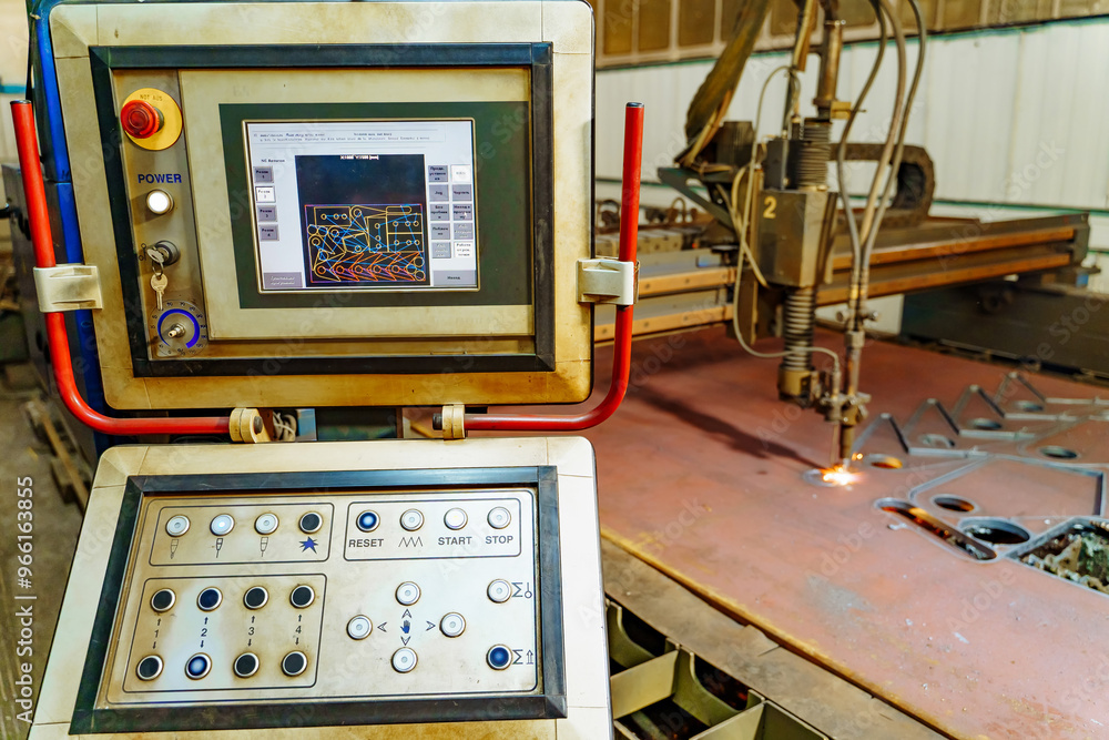 Control panel of a CNC cutting machine in a workshop during daytime. A CNC cutting machine operates with intricate control settings in a workshop. Control panel of a CNC cutting machine in a workshop during daytime. A CNC cutting machine operates with intricate control settings in a workshop.