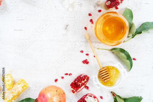 rosh hashana holiday - honey with apple and pomergranate over white desk background with copy space photo