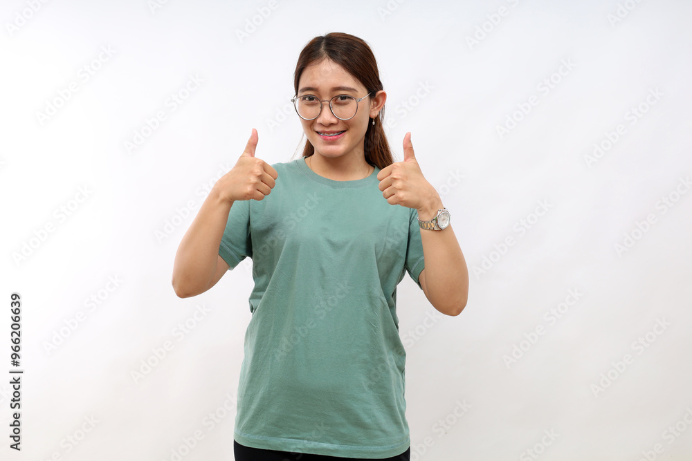 Portrait of beautiful adult asian woman showing thumbs up, recommending, standing over white background Portrait of beautiful adult asian woman showing thumbs up, recommending, standing over white background