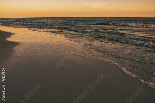Wallpaper Mural beautiful sunset along beach as waves roll in and out over warm reflecting sand. Tranquil and scenic view of vacation destination. Torontodigital.ca