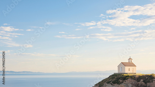 Historic Church on the Shore: Church Perched on a Coastal Hill with a Breathtaking Ocean View and Cloudy Blue Sky, Ideal for Travel and Architecture Content. photo