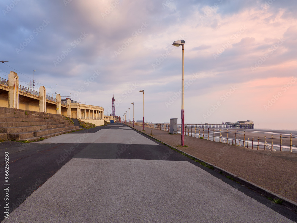 Obraz premium the seafront promenade in north Blackpool with the tower and town buildings in the distance and the north pier at low tide