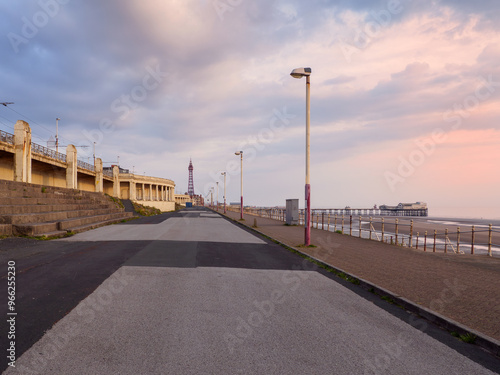 the seafront promenade in north Blackpool with the tower and town buildings in the distance and the north pier at low tide photo