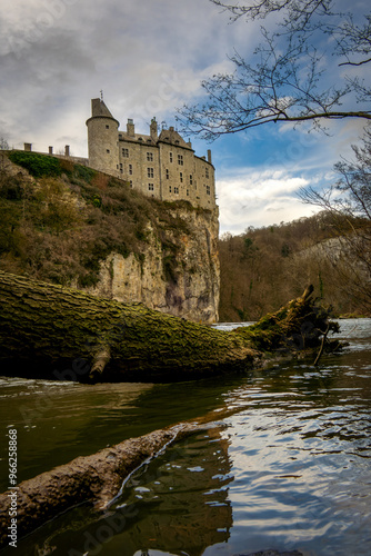 landscape photograph of the castle of Walzin situated on the heights of a hill romantic castle presenting a beautiful facade under a gray autumn sky photo