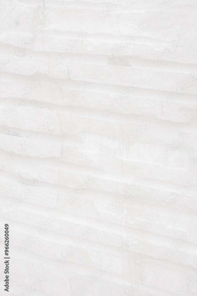 Fototapeta premium Monochrome, Light stone tiles wall with groove surface for abstract background and texture, interior or exterior design. Beautiful patterns, space for work, banner, wallpaper.Vertical.