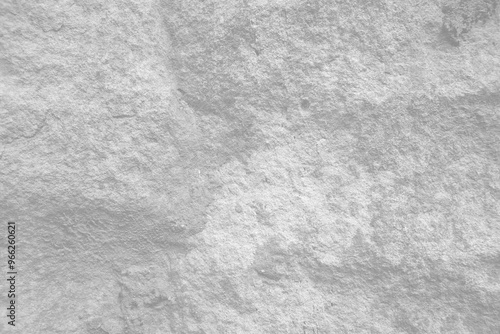 Light grey rough stone wall for abstract background and texture for interior or exterior design. Beautiful patterns, space for work, banner, wallpaper close up. photo