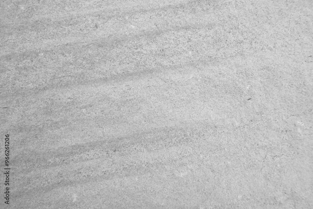 Naklejka premium Monochrome, Light grey fine rough stone wall with groove surface for abstract background and texture, interior or exterior design. Beautiful patterns, space for work, banner, wallpaper.