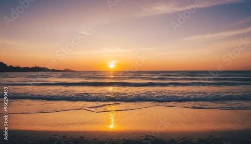 Soft Blue Waves on a Sandy Beach at Sunset