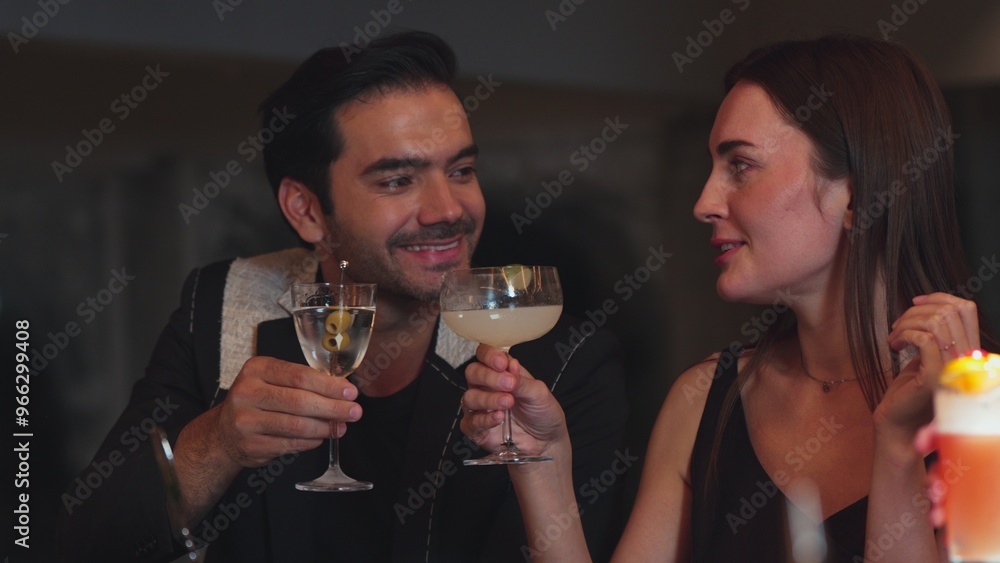 Smart couple making a toast with cocktail cheers in martini with olive and margarita savoring tasty enjoy drinking in lively conversation in good mood at bar refreshing special at nightclub. Vinosity. Smart couple making a toast with cocktail cheers in martini with olive and margarita savoring tasty enjoy drinking in lively conversation in good mood at bar refreshing special at nightclub. Vinosity.