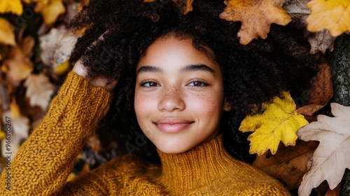 a woman with curly hair and yellow leaves photo