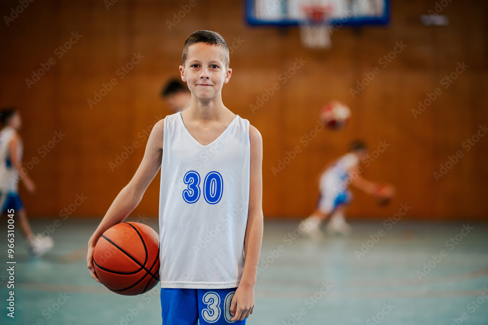 Naklejka premium Confident youth with basketball