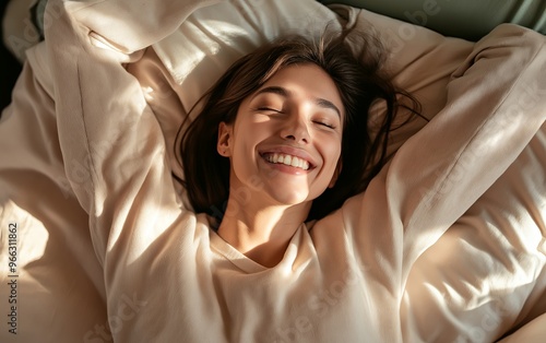 Young woman waking up with a big smile, feeling refreshed