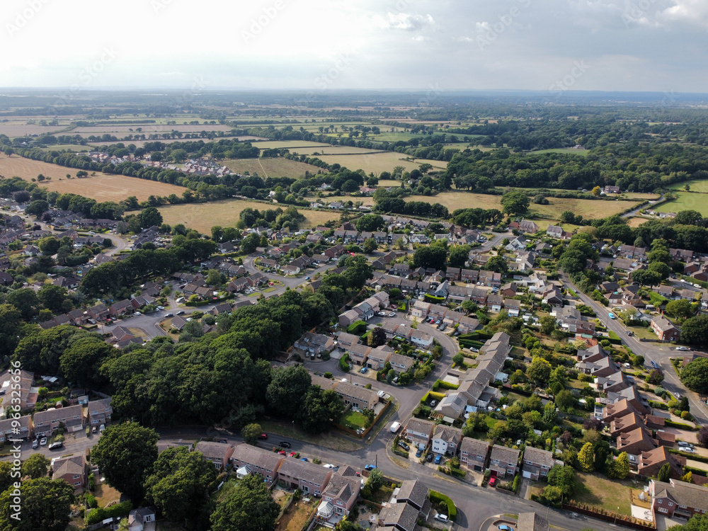 Obraz premium Aerial drone picture looking down on an area of low density housing on the edge of the countryside Bransgore village uk