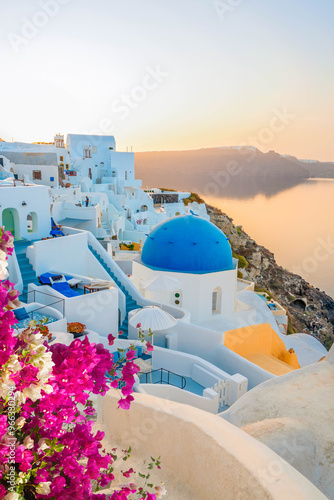 traditional greek village Oia of Santorini, with blue domes of churches and village roofs, Greece