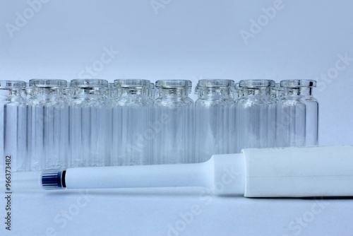 New glass vials for instrumental analysis on a white background. analytical vials prepared for chemical analysis