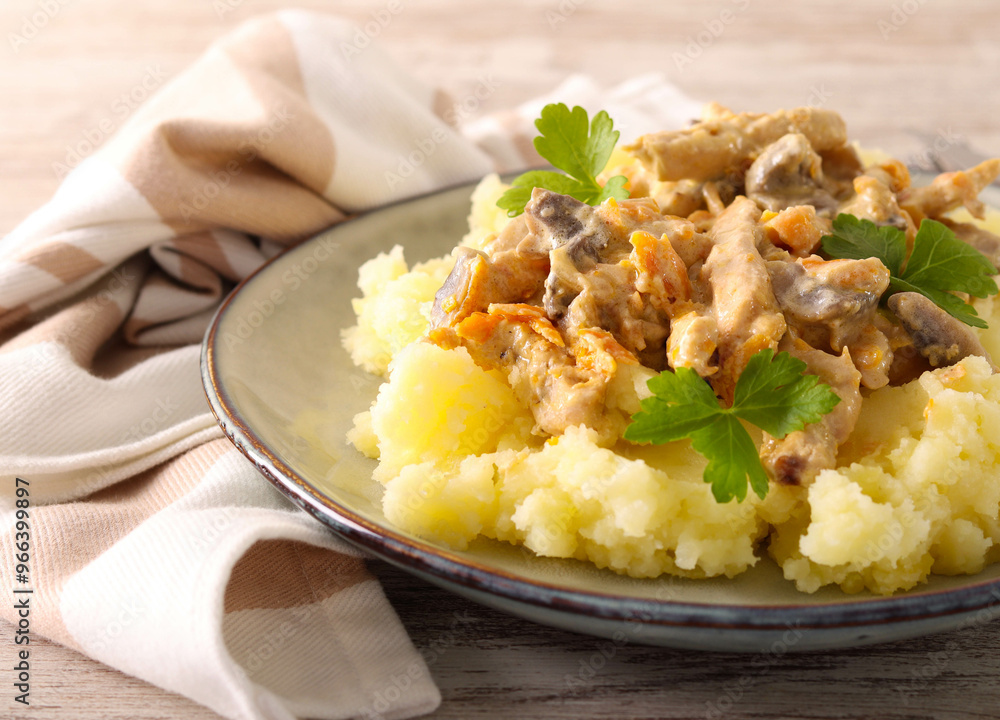 Chicken breast with mushrooms in creamy sauce over mashed potatoes Chicken breast with mushrooms in creamy sauce over mashed potatoes
