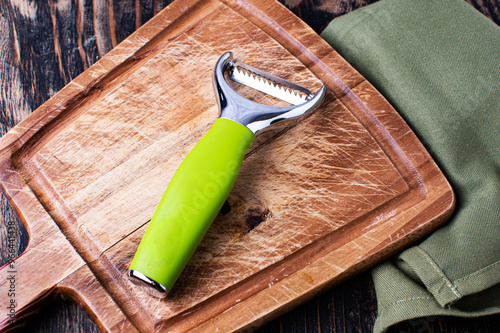 Peeler Slicer slicer on a cutting board.