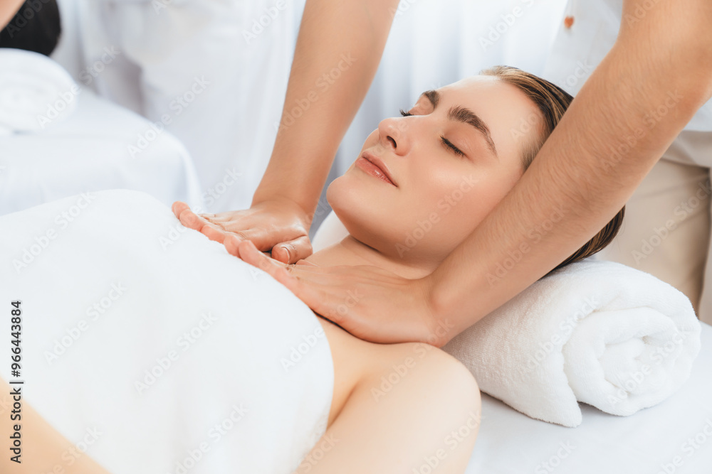 Caucasian couple customer enjoying relaxing anti-stress spa massage and pampering with beauty skin recreation leisure in day light ambient salon spa at luxury resort or hotel. Quiescent Caucasian couple customer enjoying relaxing anti-stress spa massage and pampering with beauty skin recreation leisure in day light ambient salon spa at luxury resort or hotel. Quiescent