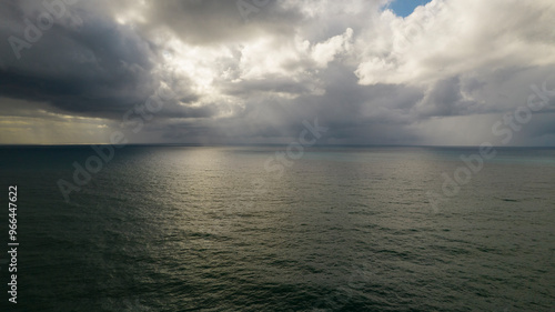 Storm on the sea with sun rays between clouds. Aerial photography