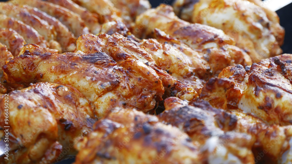 Chicken wings are fried on coals Chicken wings are fried on coals
