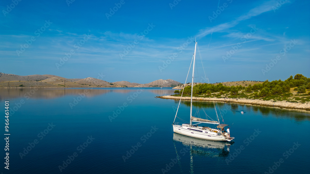 An aerial view of a serene bay on Otok Žut, located near the Kornati Islands in Croatia. The bay, surrounded by lush greenery and rocky shores, offers a tranquil retreat in the Adriatic Sea An aerial view of a serene bay on Otok Žut, located near the Kornati Islands in Croatia. The bay, surrounded by lush greenery and rocky shores, offers a tranquil retreat in the Adriatic Sea