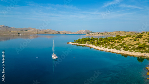 An aerial view of a serene bay on Otok Žut, located near the Kornati Islands in Croatia. The bay, surrounded by lush greenery and rocky shores, offers a tranquil retreat in the Adriatic Sea photo