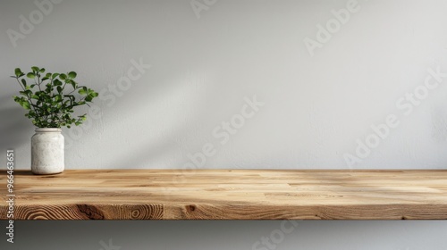 Kitchen wooden countertop on white wall background. Minimalistic room with tabletop and plant in vase for product presentation. Clean closeup mockup.