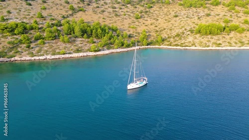 An aerial view of a serene bay on Otok Žut, located near the Kornati Islands in Croatia. The bay, surrounded by lush greenery and rocky shores, offers a tranquil retreat in the Adriatic Sea photo