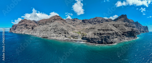 Aerial view of the trail through the mountains to Guigui beach, pristine black sand beach, Gran Canaria. Spain. Scenic trail
 photo